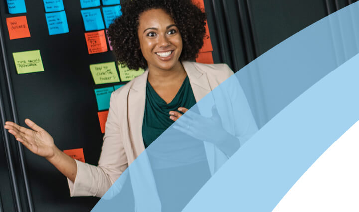 Professional Woman Talking In Front of  A Blackboard with Sticky Notes - For MSP Transition